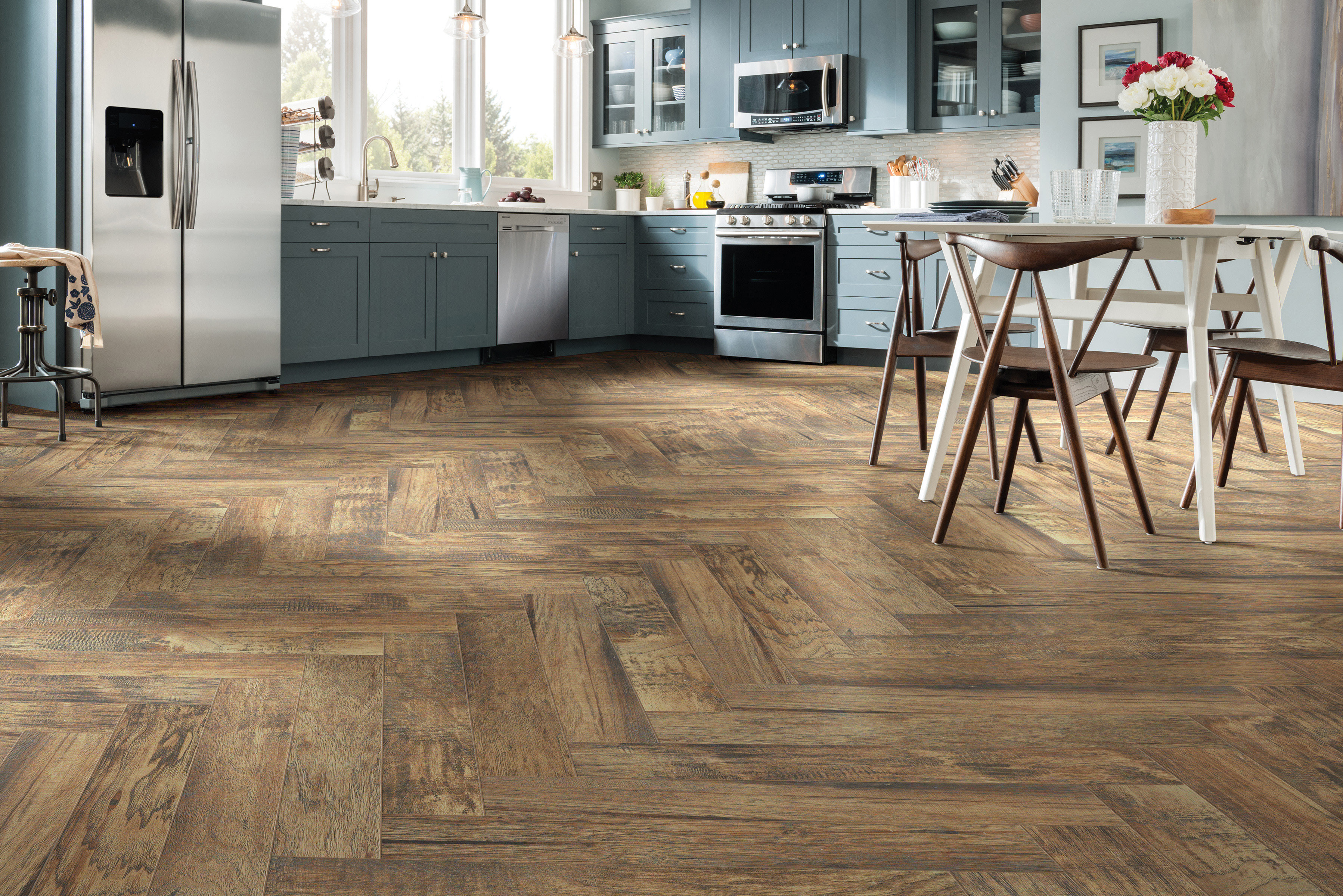 Wood-look tile in a kitchen with blue cabinets 