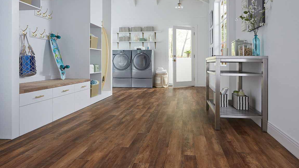 Luxury vinyl flooring in a laundry room, installation services available.