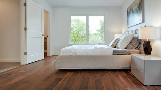beautiful hardwood flooring in a minimalist bright white bedroom